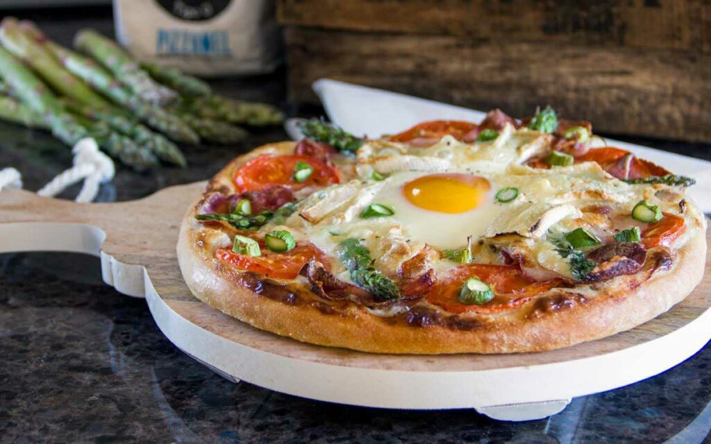 Hjemmelaget pizza med egg og asparges.